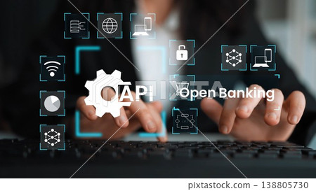Hands typing on a keyboard with digital icons representing open banking, API integration, technology, finance, and data security concepts in modern business Gluon 138805730