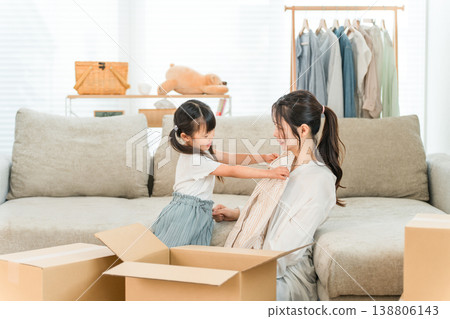 A young woman packing for a move at home, sorting out unwanted items, renting, subscribing, online shopping, using flea market apps A young woman packing for a move at home, sorting out unwanted items, renting, subscribing, online shopping, using flea market apps 138806143
