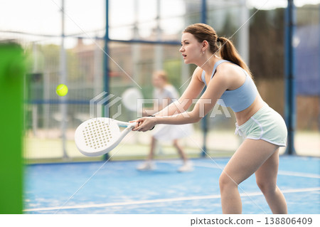 woman participates in a paddle tennis tournament 138806409