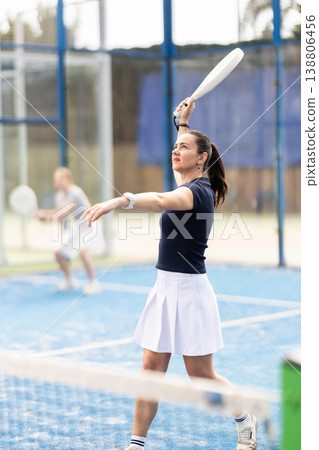 Adult woman playing doubles padel tennis 138806456