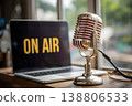 A vintage microphone and laptop displaying ON AIR live radio broadcast. 138806533