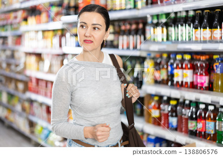 Adult woman choosing groceries in grocery store 138806576