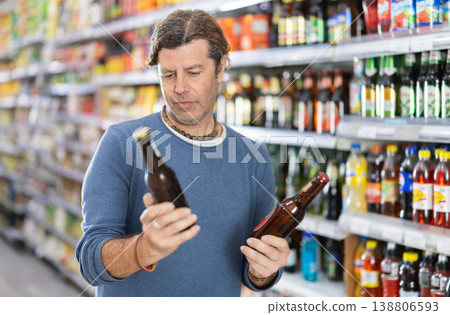 Adult man choosing beer in grocery store 138806593