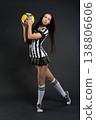 Young woman in football referee uniform posing in studio, sports concept 138806606