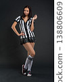 Young woman in football referee uniform posing in studio, sports concept 138806609