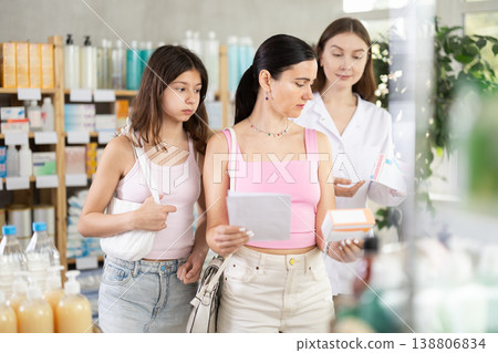 Pharmacist giving prescription pills to mother and daughter 138806834