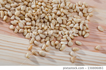 Pine nuts on a wooden surface. Natural background Pine nuts on a wooden surface. Natural background 138806861