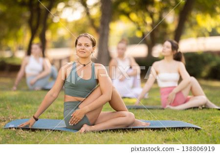 Group of young women doing yoga in park Group of young women doing yoga in park 138806919