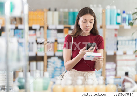 Woman scans a package of pills in a pharmacy Woman scans a package of pills in a pharmacy 138807014