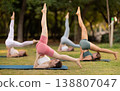 Yoga lesson visitors girls perform Salamba Sarvangasana in park 138807047