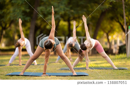 Group of young women doing yoga in park Group of young women doing yoga in park 138807051