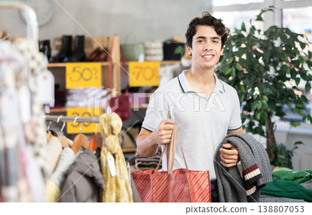 Happy male owner of purchases and new clothes. Happy male owner of purchases and new clothes. 138807053