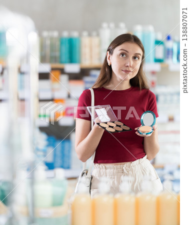 Young woman chooses cosmetics at pharmacy Young woman chooses cosmetics at pharmacy 138807071