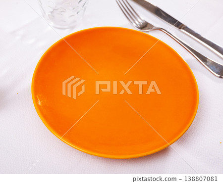 Empty plate and serving pieces on table Empty plate and serving pieces on table 138807081