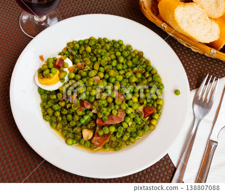 Just cooked green peas with ham and egg on plate 138807088