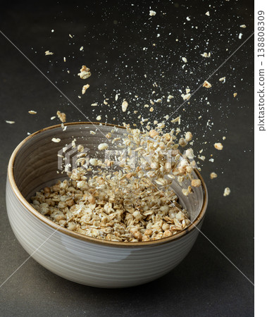 Granola falling into bowl healthy breakfast Granola falling into bowl healthy breakfast 138808309