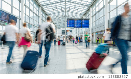 blurred motion of anonymous crowd of passengers walking with luggage inside modern bright airport terminal building near flight information departure board international journey trip blurred motion of anonymous crowd of passengers walking with luggage inside modern bright airport terminal building near flight information departure board international journey trip 138808837