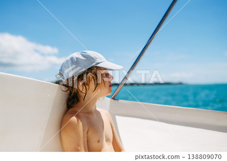 Child relaxing on boat during tropical family vacation. Child relaxing on boat during tropical family vacation. 138809070