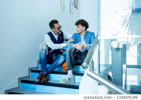 Teacher supporting struggling student. Boy confiding in a teacher. Teacher supporting struggling student. Boy confiding in a teacher. 138809196