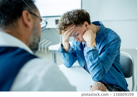 Teacher supporting struggling student. Boy confiding in a teacher. 138809199