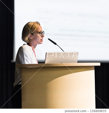 Female speaker giving a talk on corporate business conference. Business and Entrepreneurship event Female speaker giving a talk on corporate business conference. Business and Entrepreneurship event 138809635
