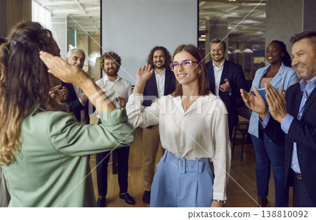 Happy colleagues giving high five at meeting at office, celebrating success or business achievement 138810092