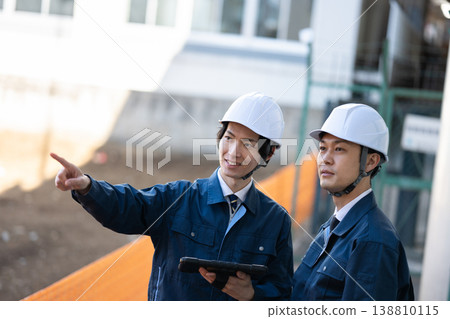 Engineers having a conversation Engineers having a conversation 138810115