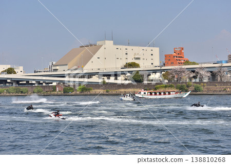 A group of jet skis going up the Sumida River 138810268