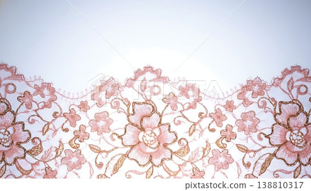 Delicate pink lace fabric with floral embroidery featuring intricate designs and scalloped edges against a soft white background for textile and fashion applications 138810317