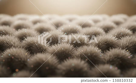 Close-up view of textured surface featuring numerous soft, fuzzy spheres with shimmering highlights, creating an abstract pattern in a warm, softly lit environment Close-up view of textured surface featuring numerous soft, fuzzy spheres with shimmering highlights, creating an abstract pattern in a warm, softly lit environment 138810332