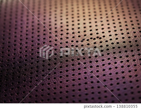 Close-up view of textured purple leather material with perforated holes, showcasing the intricate design and craftsmanship of the fabric surface Close-up view of textured purple leather material with perforated holes, showcasing the intricate design and craftsmanship of the fabric surface 138810355