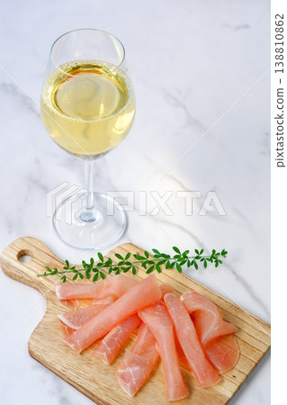 Wine and Prosciutto - Enjoy delicious, salty prosciutto as a snack with a glass of dry white wine. Wine and Prosciutto - Enjoy delicious, salty prosciutto as a snack with a glass of dry white wine. 138810862