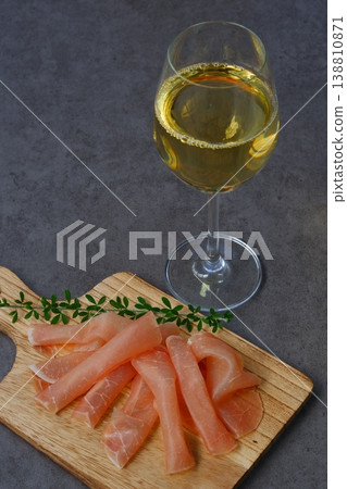 Wine and Prosciutto - Enjoy delicious, salty prosciutto as a snack with a glass of dry white wine. Wine and Prosciutto - Enjoy delicious, salty prosciutto as a snack with a glass of dry white wine. 138810871
