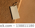 Blank Hanging Tag Mockup with String on Rustic Clay Wall Background. Minimal Paper Label Template, Natural Texture. Elegant Branding Tag for Packaging, Craft Product. Summer Sale Price Label Design 138811180