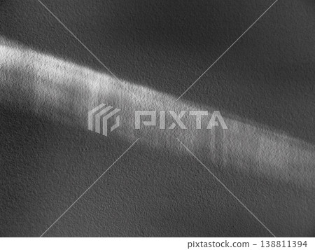 A ray of sunlight on a white plaster wall. The texture is an abstraction. 138811394