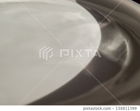 A white plate. An abstract, muted composition. Glare. 138811399