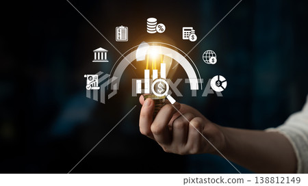 Person Holding Light Bulb with Financial Icons and Graphs Representing Innovation in Investment and Financial Growth Concepts Ledger Person Holding Light Bulb with Financial Icons and Graphs Representing Innovation in Investment and Financial Growth Concepts Ledger 138812149