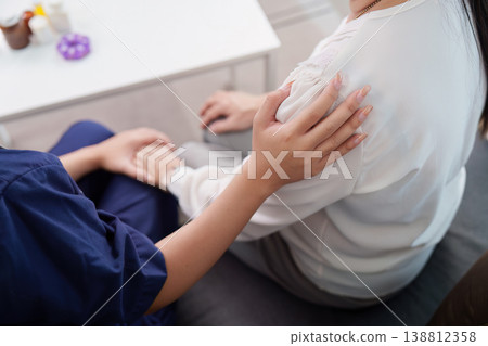Nurse providing compassionate care to elderly woman at home 138812358