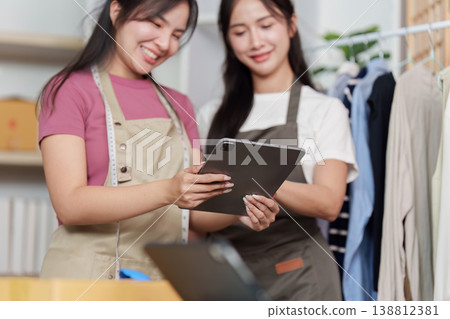 Entrepreneurs reviewing business data on tablet Entrepreneurs reviewing business data on tablet 138812381