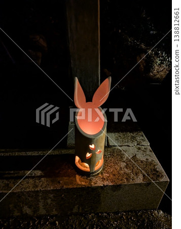 A bamboo lantern shaped like a rabbit, illuminated by paper lanterns. A bamboo lantern shaped like a rabbit, illuminated by paper lanterns. 138812661