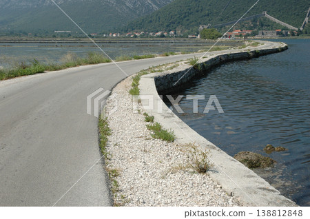 Coastal road passing by Ston salt pans and medieval walls in Croatia Coastal road passing by Ston salt pans and medieval walls in Croatia 138812848
