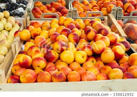 Heap of red yellow nectarines at a local organic farmers market. Colorful display of local market Heap of red yellow nectarines at a local organic farmers market. Colorful display of local market 138812932