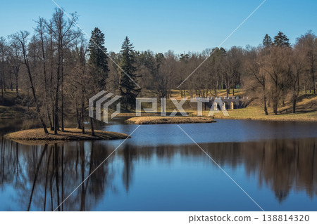Oranienbaum Spring Sun Park. Still lake mirrors trees and sky Oranienbaum Spring Sun Park. Still lake mirrors trees and sky 138814320