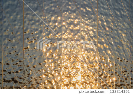 The fluted mirror reflects the golden evening light. The fluted mirror reflects the golden evening light. 138814391