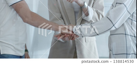 Business people joining hands together, demonstrating their strong teamwork and collaboration in achieving shared goals. Business people concept Business people joining hands together, demonstrating their strong teamwork and collaboration in achieving shared goals. Business people concept 138814530