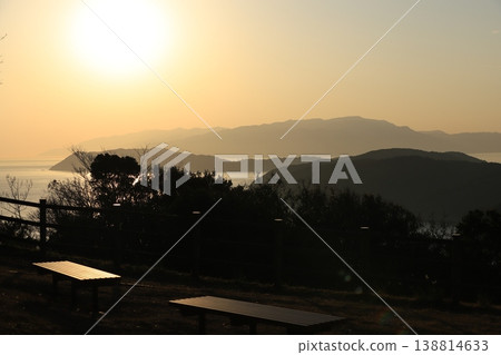 A bench with a view of the sea and the sunset 138814633