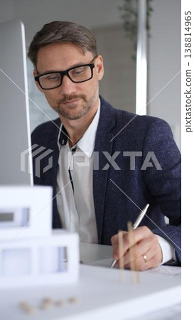 Architect developing building blueprint on computer, engineering and urban planning a new construction project. Business and architecture concept Architect developing building blueprint on computer, engineering and urban planning a new construction project. Business and architecture concept 138814965