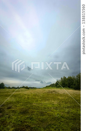 A Serene Open Landscape Featuring a Stunning and Dramatic Sky Filled with Clouds and Color A Serene Open Landscape Featuring a Stunning and Dramatic Sky Filled with Clouds and Color 138815560