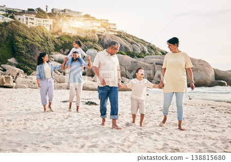 Big family, holding hands and walking at a beach for travel, vacation and fun in nature together. Freedom, parents and children relax with grandparents at the sea on holiday, trip or ocean adventure Big family, holding hands and walking at a beach for travel, vacation and fun in nature together. Freedom, parents and children relax with grandparents at the sea on holiday, trip or ocean adventure 138815680