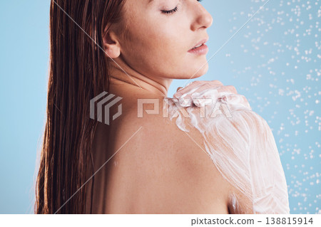 Woman, shower and soap for body hygiene, washing or cleaning against a blue studio background. Female person in relax for soapy scrub, wash or rain drops for skincare, self love or healthy wellness Woman, shower and soap for body hygiene, washing or cleaning against a blue studio background. Female person in relax for soapy scrub, wash or rain drops for skincare, self love or healthy wellness 138815914